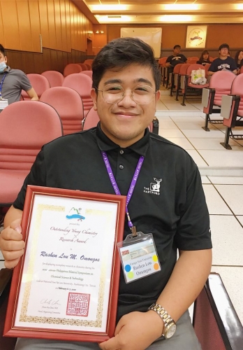 Mr. Omongos shows off his certification of Outstanding Young Chemistry Research Award